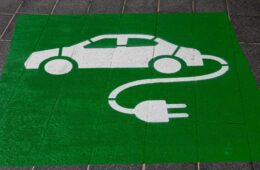 electric car logo with green and spray paint