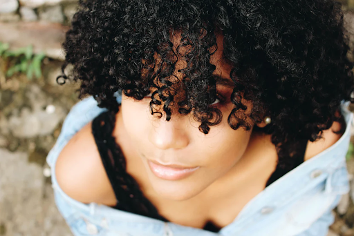 a young black women with short but very curly dark hair