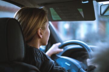 a young teenage girl driving a car