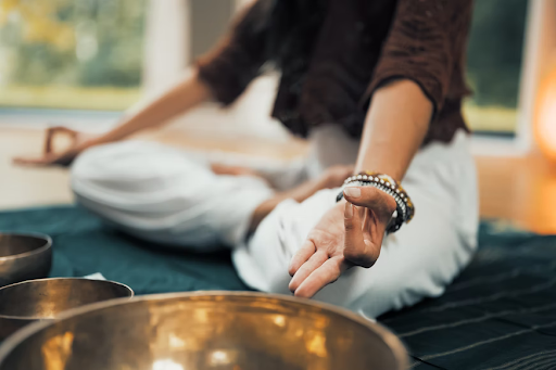 a woman meditation with sound bowls for tantra