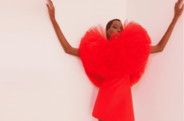 A model poses in a red tulle ensemble from Carolina Herrera F/W 2022