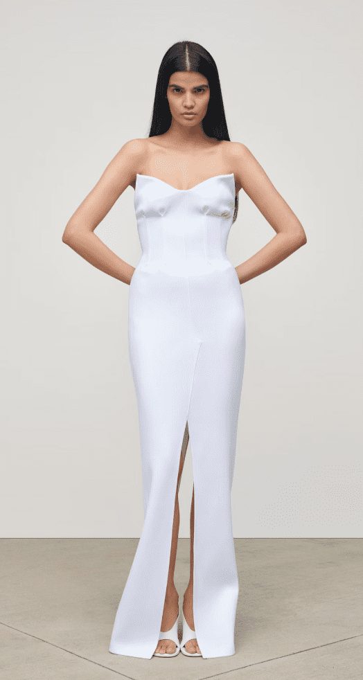 model wearing white floor length gown