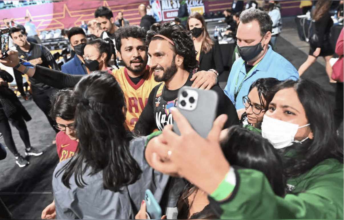 Ranveer Singh seen taking a picture with fans.