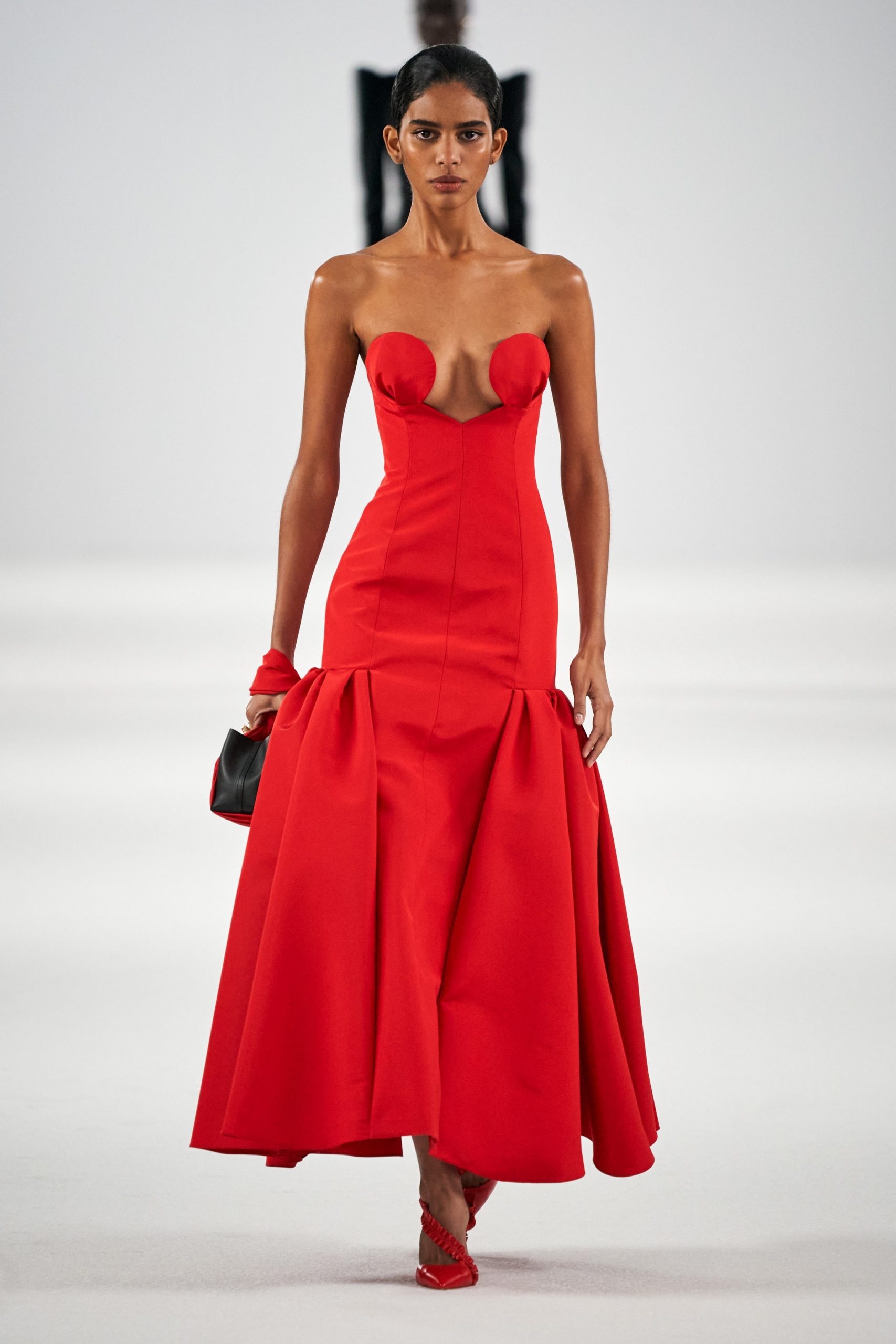 A model wears a glamorous red evening dress for Carolina Herrera F/W 2022