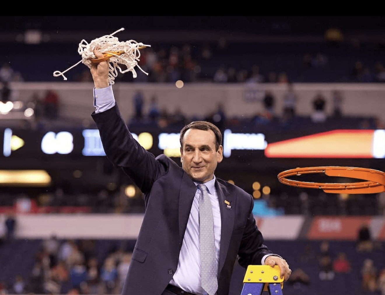 Coach K Holding Basketball Net