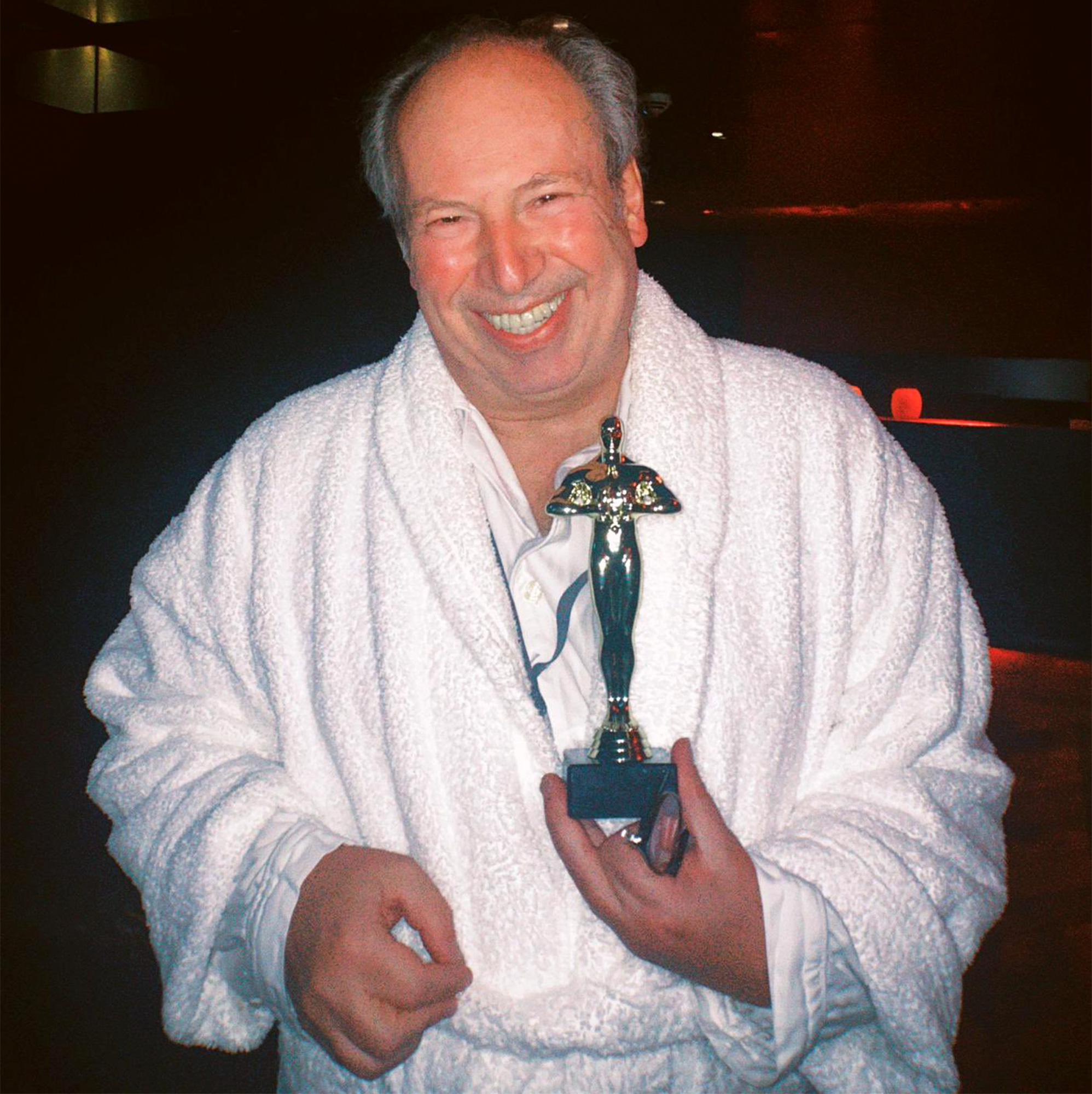 Hans Zimmer accepts his award in a gown.