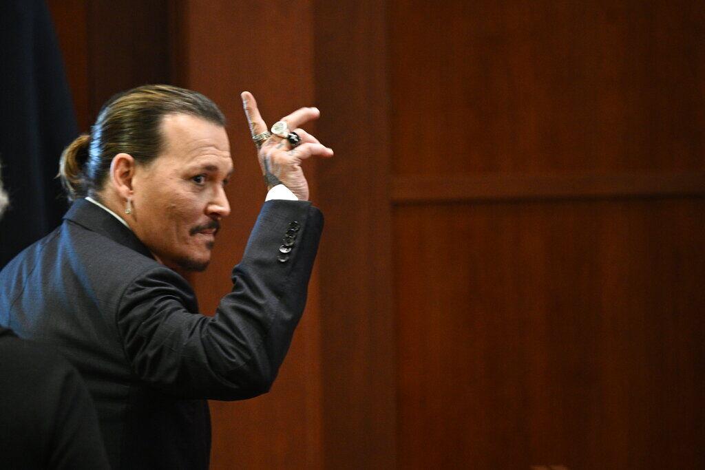 Actor Johnny Depp gestures as he walks out of the courtroom during a break at the Fairfax County Circuit Courthouse in Fairfax, Va., Tuesday, May 17, 2022. Actor Johnny Depp sued his ex-wife Amber Heard for libel in Fairfax County Circuit Court after she wrote an op-ed piece in The Washington Post in 2018 referring to herself as a "public figure representing domestic abuse."