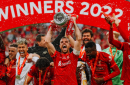 Liverpool captain Jordan Henderson lifts the trophy with his team.