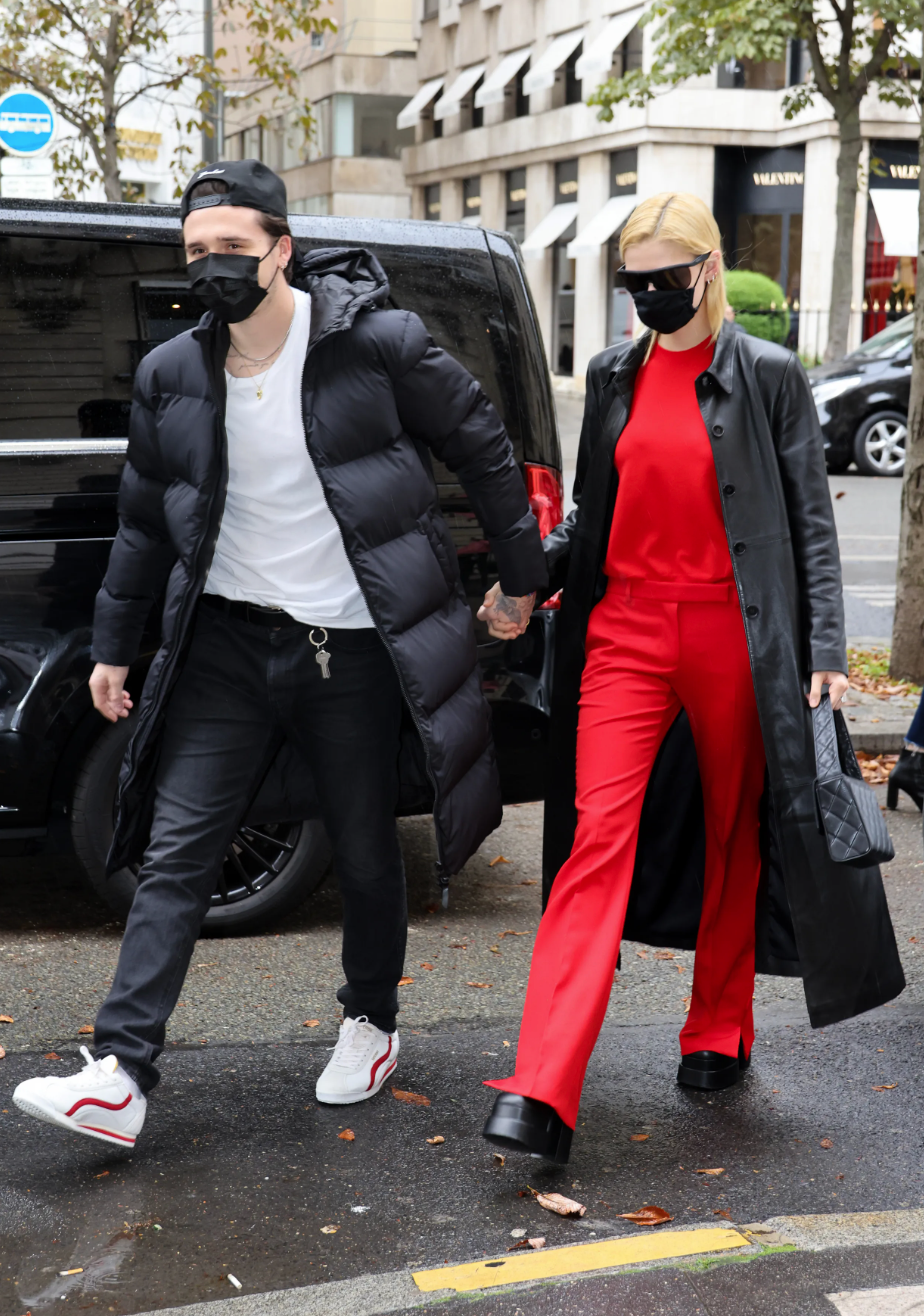 Peltz wears a red set with a black trench