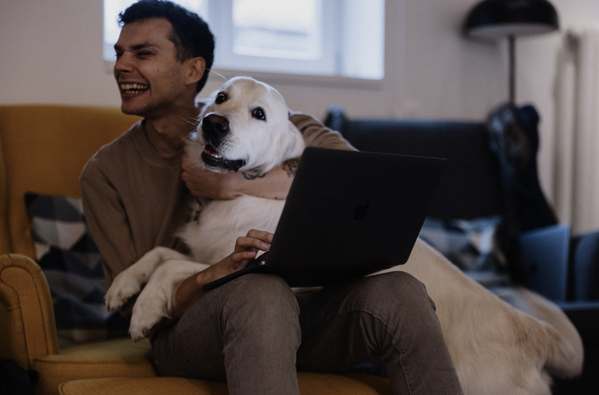 Man with dog on the computer