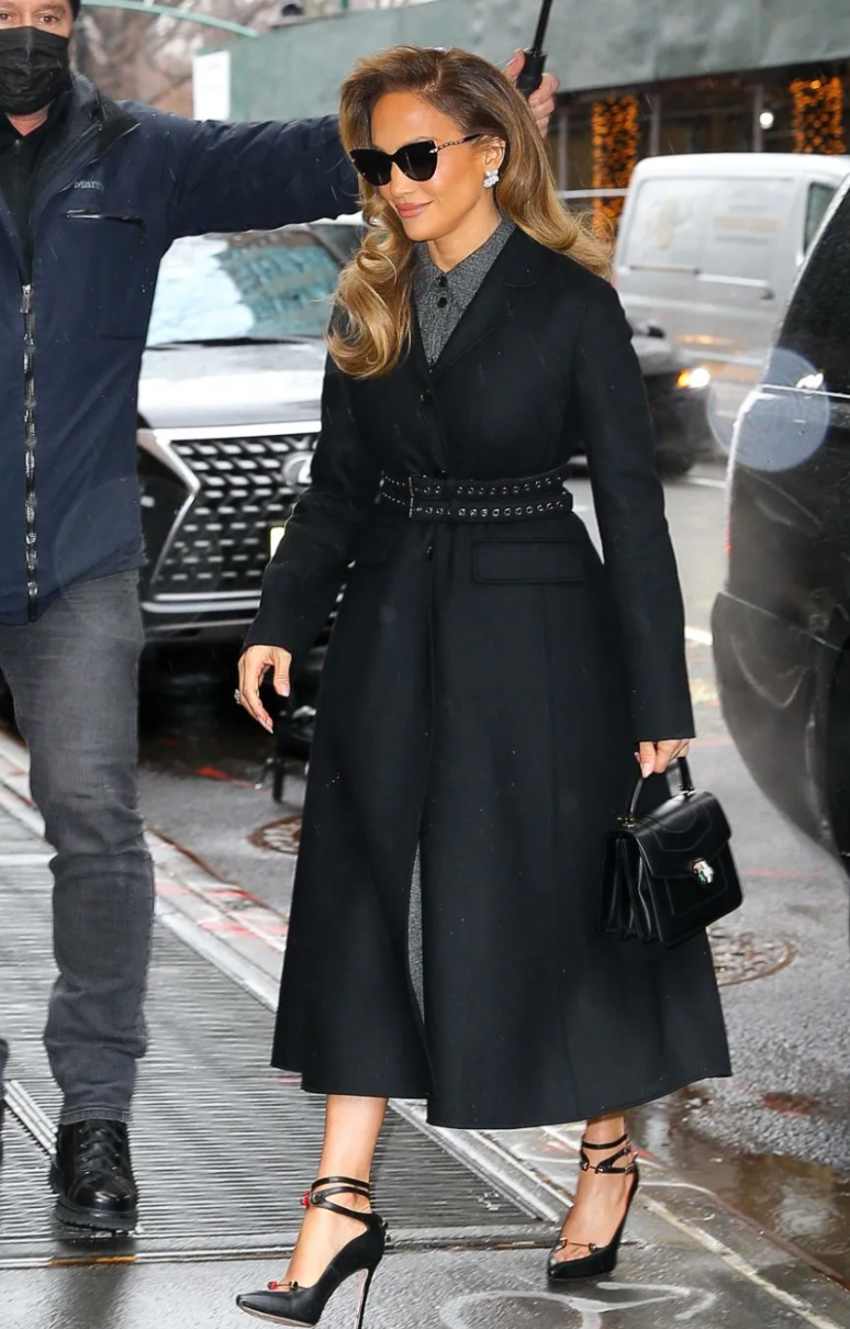 Jennifer Lopez wearing a trench coat.