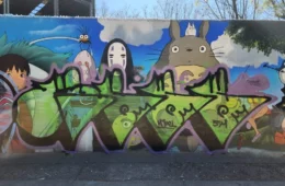 A mural of Studio Ghibli scenes being vandalized.