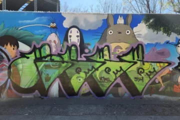 A mural of Studio Ghibli scenes being vandalized.
