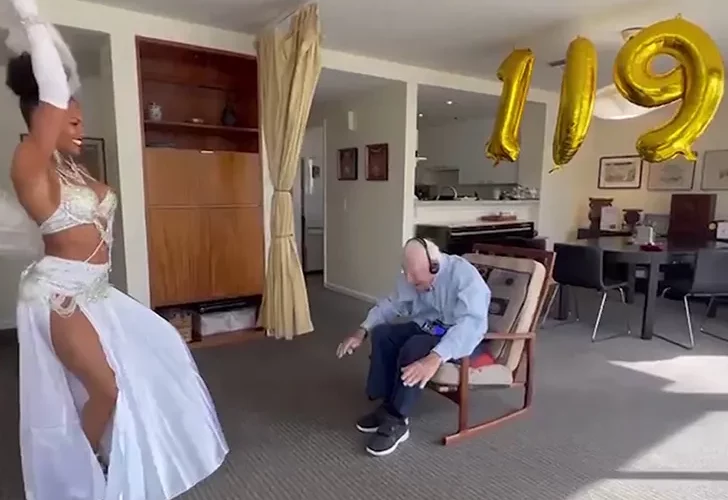 A grandpa enjoys a belly dancing performance