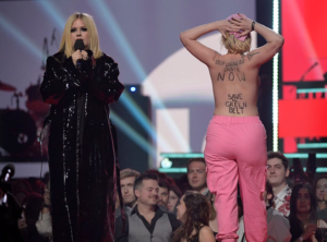 Avril Lavigne and protestor on stage ay Juno Awards 2023.