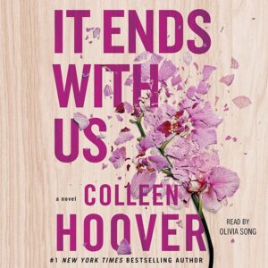 The Book cover of 'It Ends With Us' by Colleen Hoover. A light wood background 'It Ends With Us' and 'Colleen Hoover' in fuchsia lettering and light pink/ fuchsia flowers entwined with the words.