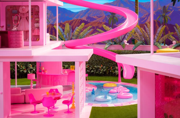 A view of Barbie's fuchsia Dreamhouse reveals the living and dining areas on the first level and the walk-in closet on the second