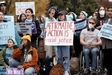 People rally outside the Supreme Court as the court begins to hear oral arguments in two cases that could decide the future of affirmative action in college admissions