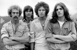 A black and white photo of the band 'The Eagles' from left to right: Bernie Leadon, Randy Meisner, Don Henley and Glenn Frey