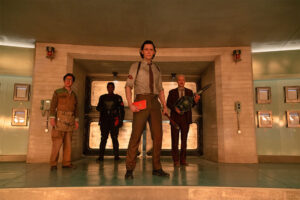 from Loki season 2 trailer. Standing with their backs facing a closed doorway (from left to right) Ke Huy Quan, Wunmi Mosaku, Tom Hiddleston and Owen Wilson.
