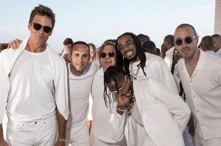Michael Rubin posing with famous guests at his Fourth of July White Party.