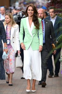 Kate Middleton walking to Wimbledon 2023 in a mint jacket and white skirt.