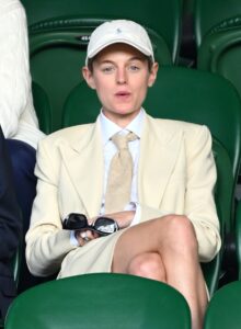 Emma Corrin sitting at Wimbledon 2023 looking invested.