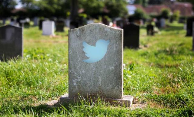 A picture of a tombstone with the Twitter logo on it.