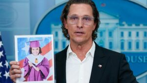 Matthew McConaughey speaks to reporters at a White House briefing about the Uvalde Elementary School shooting. He's holding up a picture of a young victim in her graduation photo.