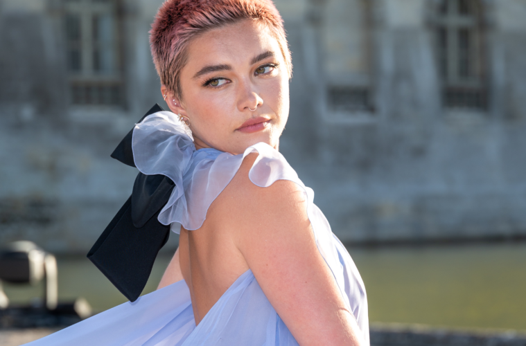Florence Pugh at the Valentino Couture fashion show in a sheer blue gown or buzzed pink hair.
