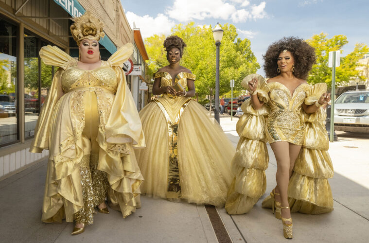 Eureka O'Hara, Bob The Drag Queen, and Shangela walking down a 'small town' street in gold costumes