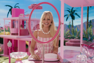 A screenshot of Margot Robbie as Barbie getting ready in her dream house.