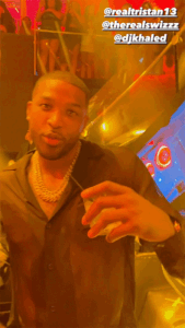 Tristan Thompson dancing with drinks in his hands at LIV nightclub