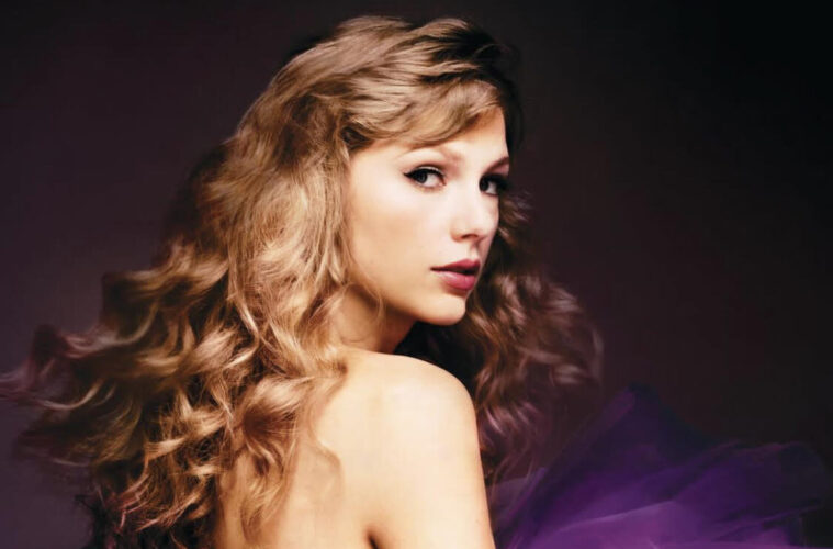 Album Cover of 'Speak Now (Taylor's Version)' Taylor is in an off the shoulder puffy purple tule dress and her hair is curled.