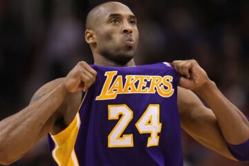 Kobe Bryant pulling out the front of his Lakers basketball jersey