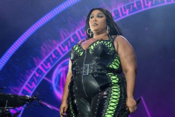 Lizzo performs in her 'Special' Tour in a green and black jumpsuit