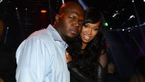 Bobby McCray (left) and Khadijah Haqq posing for a photo together in a night club.