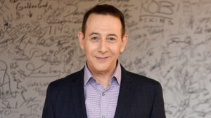  Paul Reubens (older in age) at the 'AOL Build Speaker Series'. He's wearing a dark suit jacket with a purple undershirt