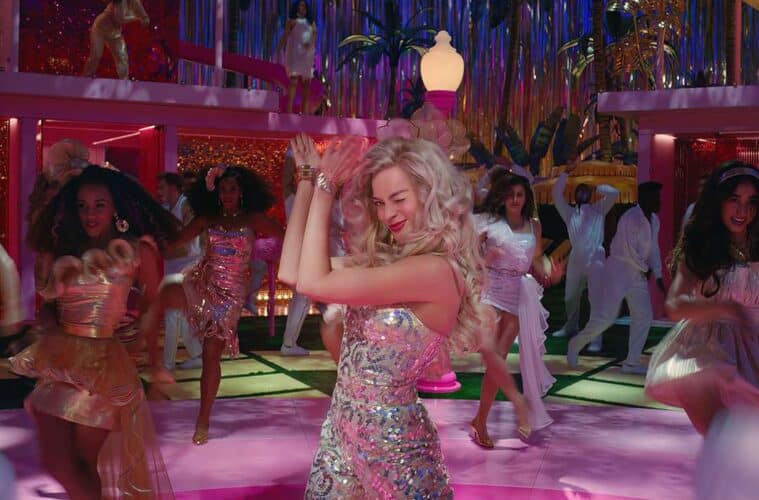 Margot Robbie clapping and winking as 'stereotypical Barbie' at her dream house dance party