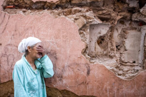 A woman reacts (crying) to Morocco earthquake in front of damaged home