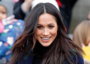 Meghan Markle greeting fans on a street in England.