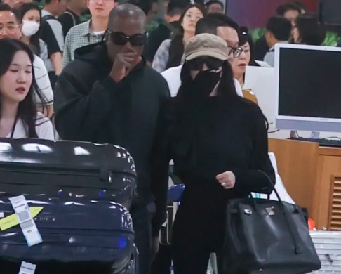 Bianca Censori Covers Up Head-to-Toe & Carries Birkin at Seoul Airport with Kanye West