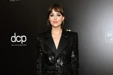 Dakota Johnson dress in black classic blazer looking effortless at an event