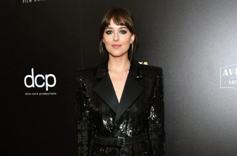 Dakota Johnson dress in black classic blazer looking effortless at an event