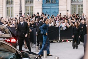 Celebrity arrives outside Paris Fashion Week show amid a crowd of fans