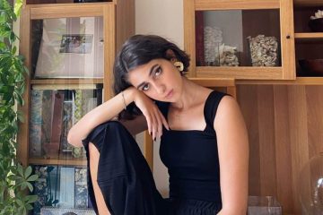 Rama Duwaji poses in her home in a fashion forward black dress