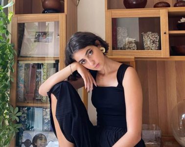 Rama Duwaji poses in her home in a fashion forward black dress