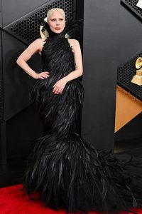 Lady Gaga wearing a dramatic feathered couture gown at the 2026 Grammy Awards red carpet.