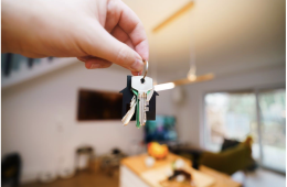 Hand Holding Keys in Modern Home Interior