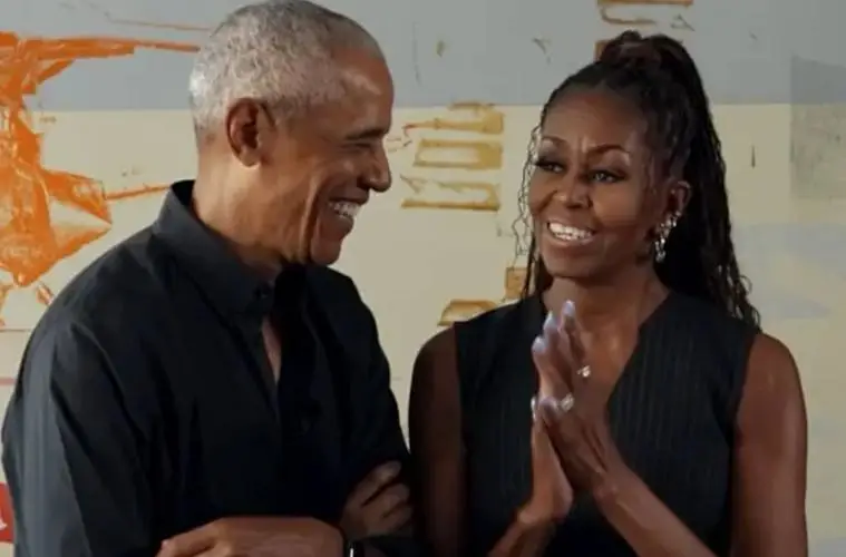 Barack and Michelle Obama smiling together while discussing the perfect date night at the Obama Presidential Center in Chicago.
